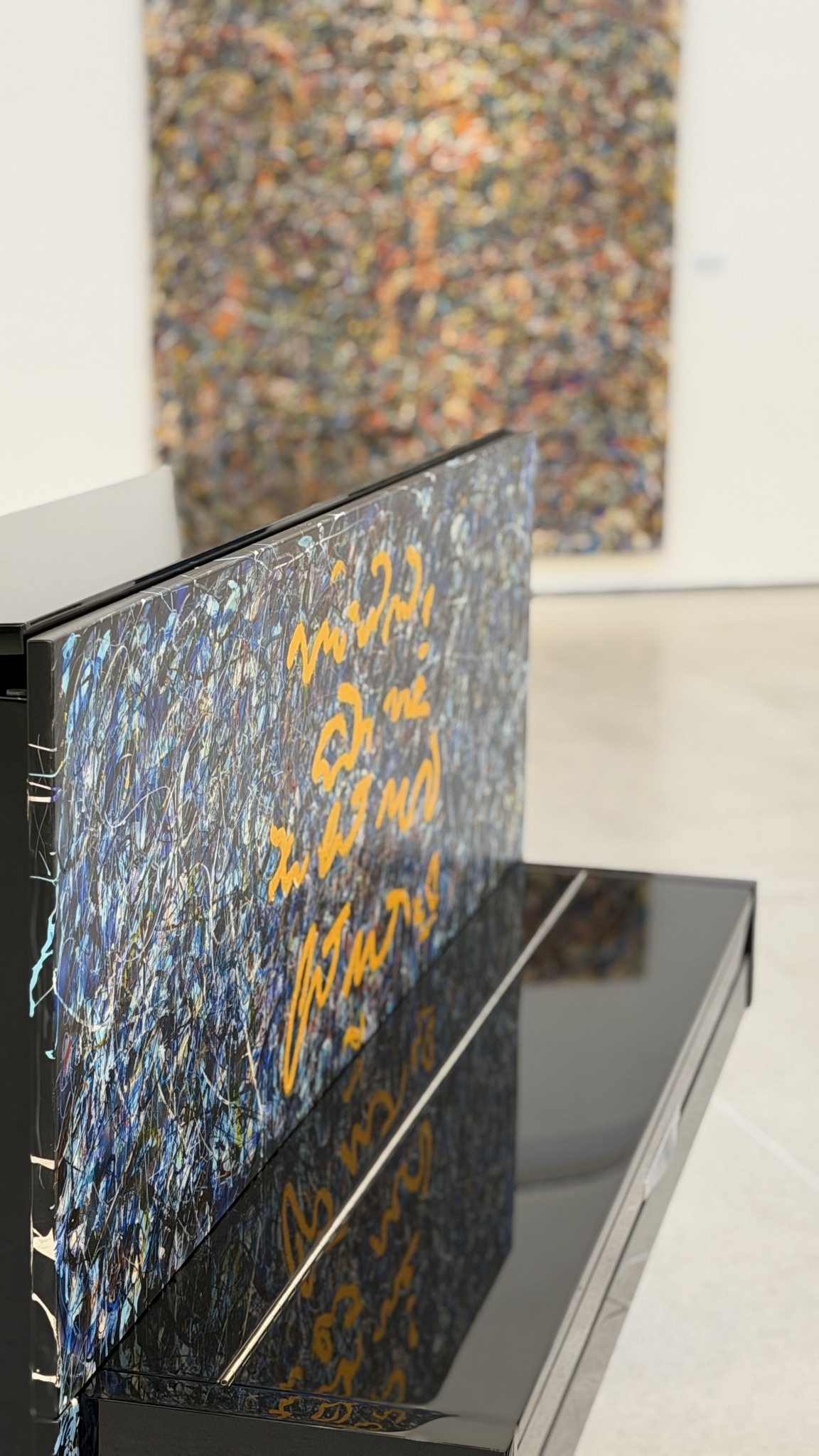 The painted piano surface and the gallery beyond